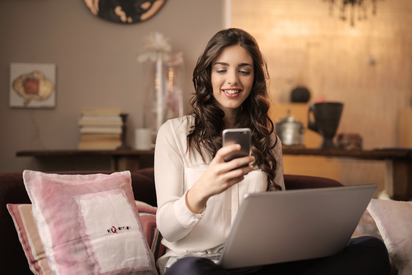 C:\Users\PROBOOK\AppData\Local\Microsoft\Windows\INetCache\Content.Word\woman-sitting-on-sofa-while-looking-at-phone-with-laptop-on-920382.jpg